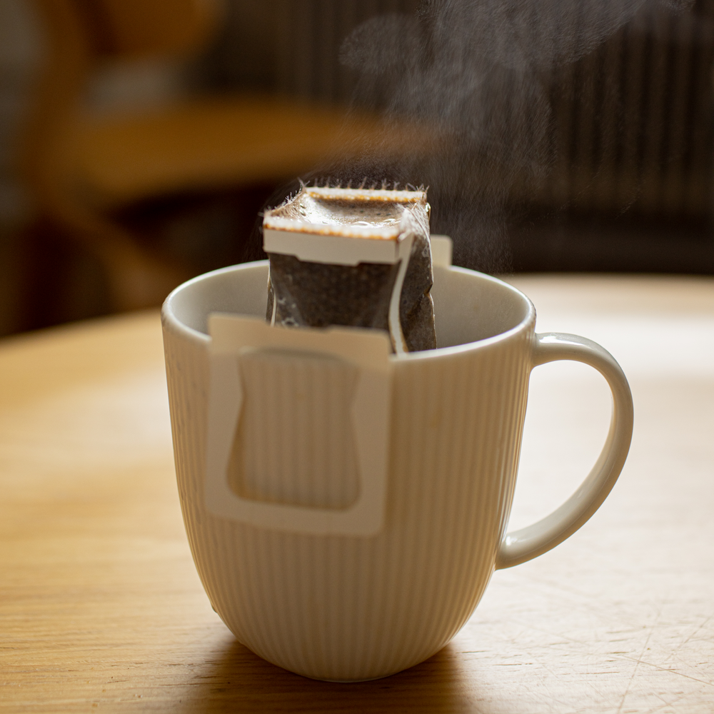 Drip bag specialty coffee brewing in the white cup